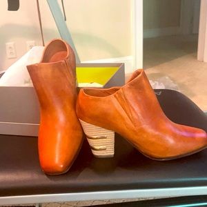 Shoe booties with a wooden heel.